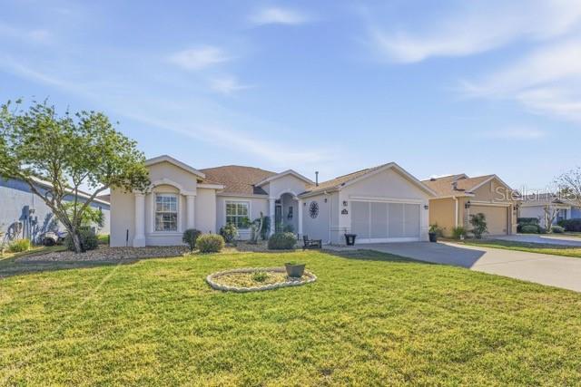 1338 Southwest 161st Place Ocala, FL 34473 - Photo 5 of 76 a front view of a house with a yard and large tree