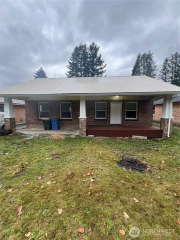 a view of a house with a backyard porch and furniture