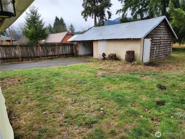 a backyard of a house with table and chairs