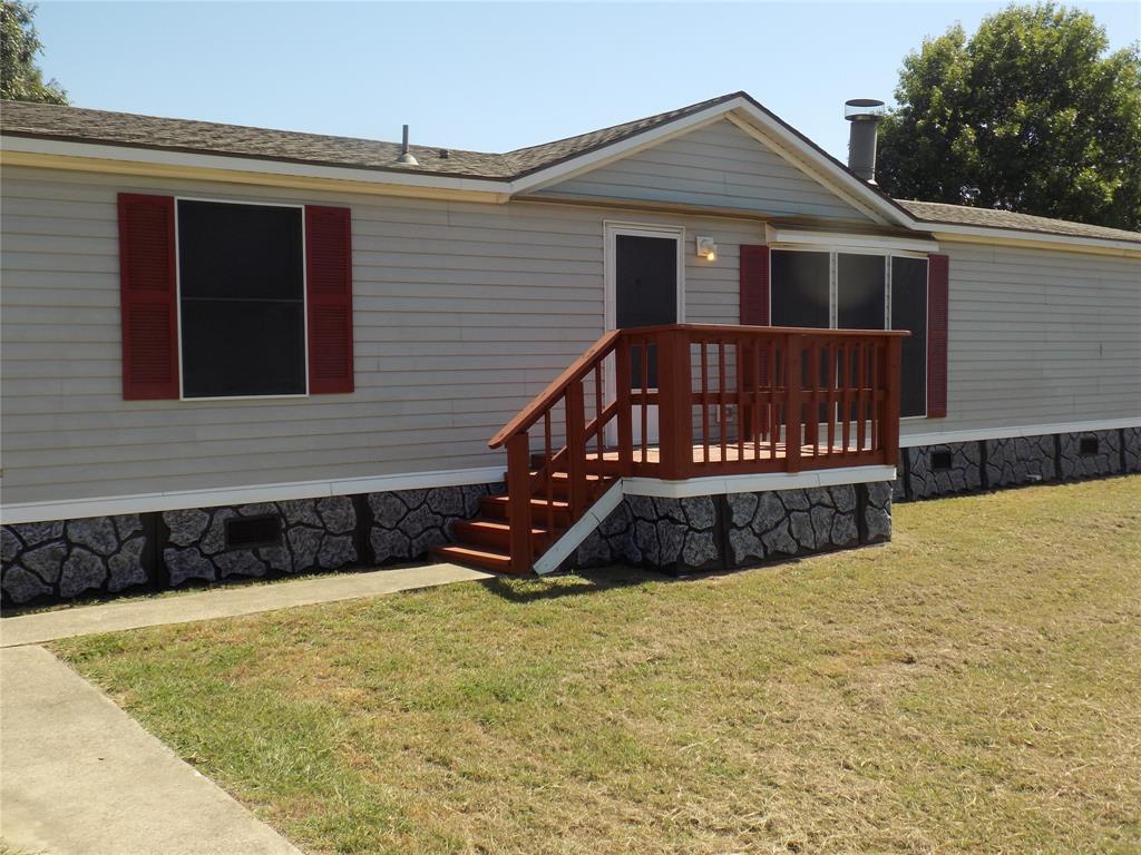 a view of a house with wooden fence