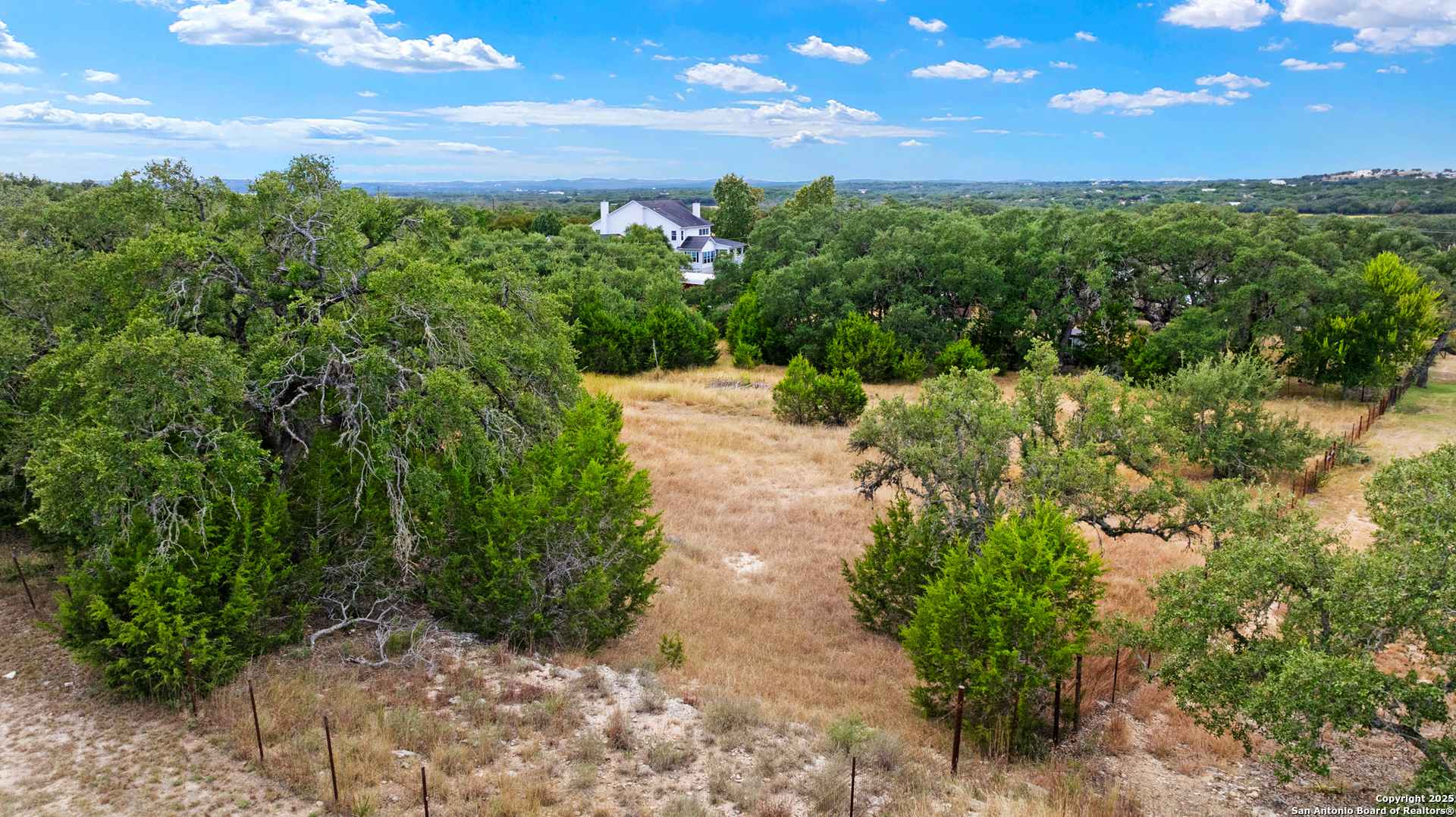 32311 Koch Road Bulverde, TX 78163 - Photo 14 of 14 a view of a pathway both side of grassy field with trees