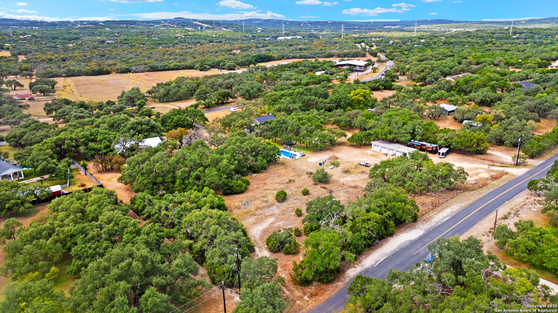 32311 Koch Road Bulverde, TX 78163 - Photo 8 of 14 an aerial view of green landscape with trees houses and mountain view