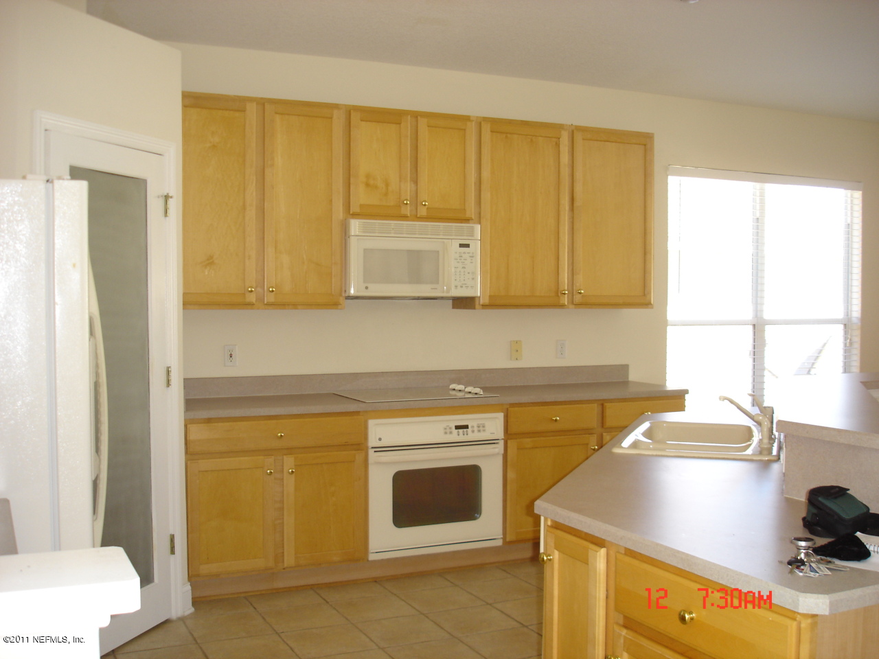 620 Pelham Road St. Augustine, FL 32092 - Photo 4 of 8 a kitchen with a sink a stove and cabinets