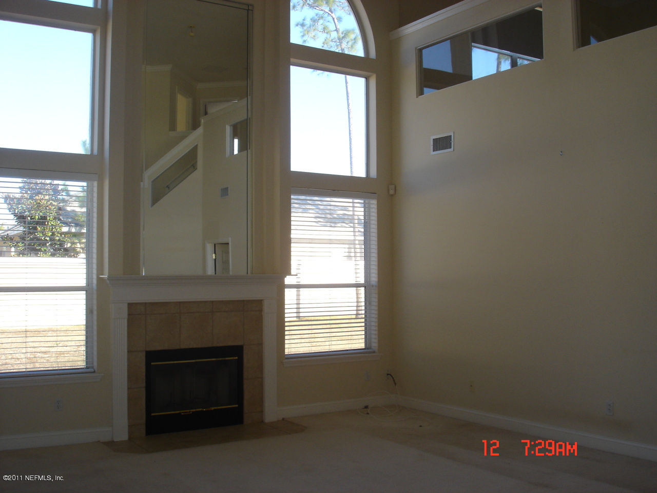 620 Pelham Road St. Augustine, FL 32092 - Photo 8 of 8 a view of an empty room with a fireplace and a window
