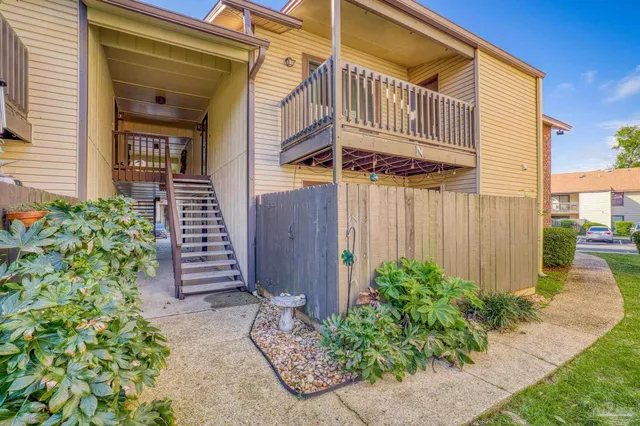 a view of a house with wooden fence