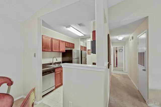 a kitchen with stainless steel appliances granite countertop a refrigerator sink and cabinets