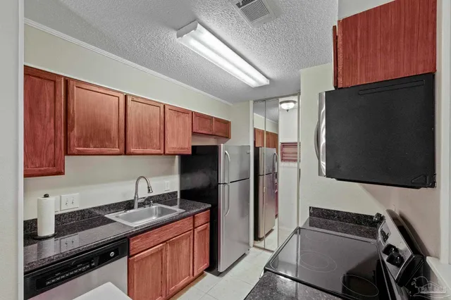 a kitchen with a sink stove and refrigerator