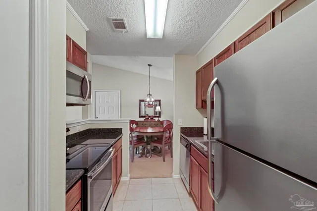 a kitchen with a refrigerator and a stove