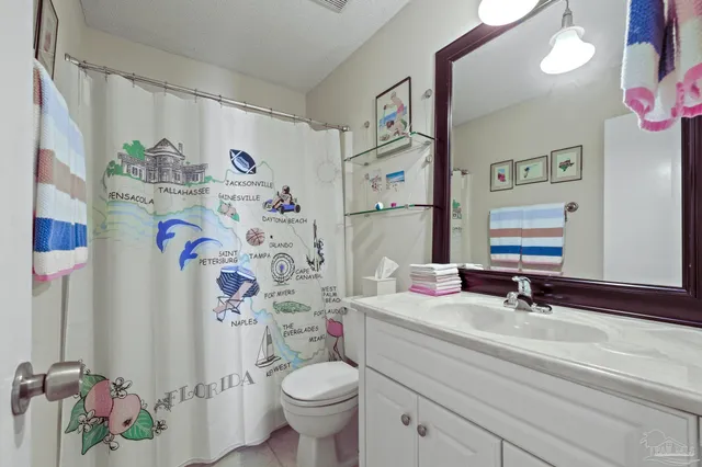 a bathroom with a sink vanity mirror and toilet