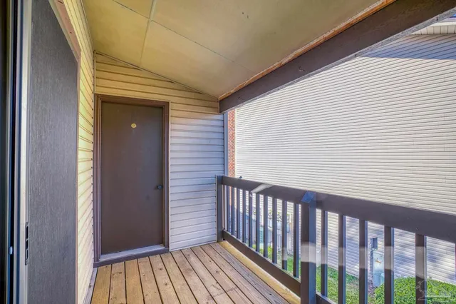 a view of a balcony with wooden floor
