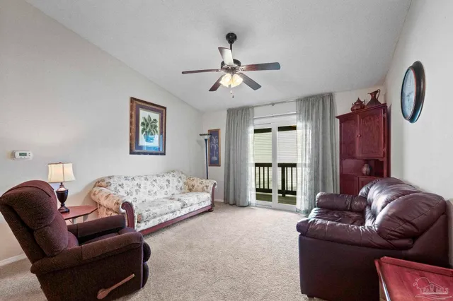 a spacious bedroom with a bed couch and window
