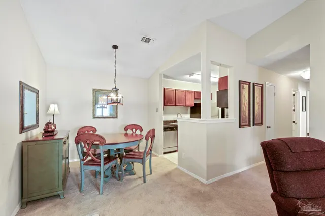 a view of a dining room with furniture and chandelier