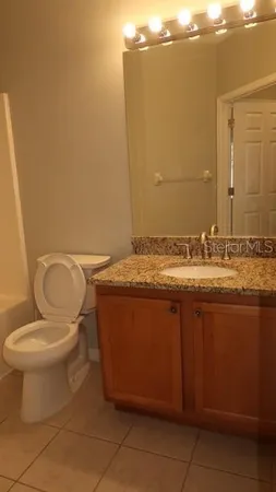 a bathroom with a toilet a sink and shower