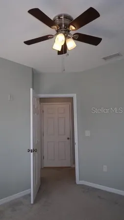 a view of a chandelier fan and a bathroom