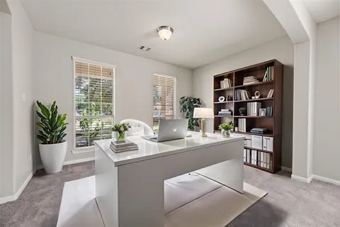 a dining room with stainless steel appliances kitchen island granite countertop a living room view