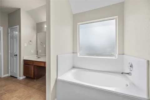 a bathroom with a bathtub and a sink