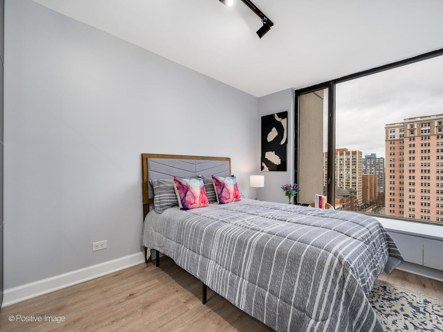 5455 North Sheridan Road, Unit 1511 Chicago, IL 60640 - Photo 11 of 25 a bedroom with a large bed and a large window