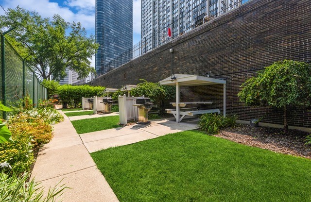 5455 North Sheridan Road, Unit 1511 Chicago, IL 60640 - Photo 22 of 25 a view of a chair and table in backyard of the house