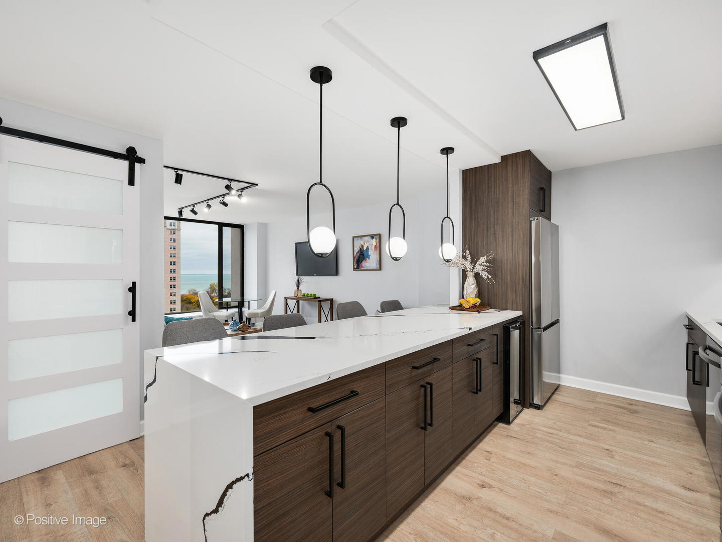 5455 North Sheridan Road, Unit 1511 Chicago, IL 60640 - Photo 3 of 25 a view of a kitchen counter space a sink a refrigerator and windows