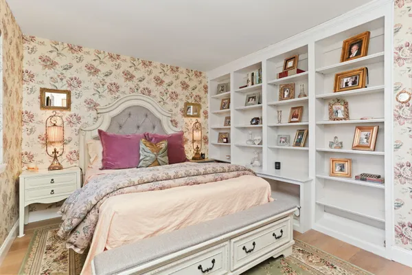 a bedroom with a bed and a book shelf