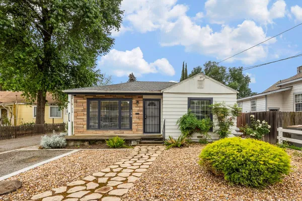 a front view of a house with garden