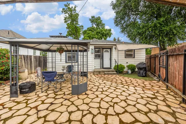 a kitchen with stainless steel appliances a sink a stove a refrigerator cabinets and a window