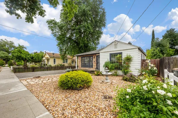 a front view of a house with garden