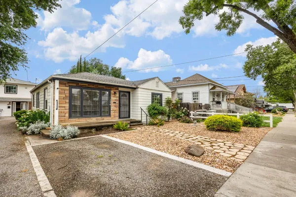 a front view of a house with garden