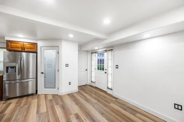 a kitchen with stainless steel appliances granite countertop a lot of cabinets and wooden floor