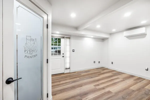 a view of kitchen with wooden floor and electronic appliances