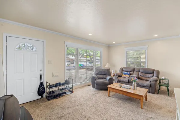 a view of a workspace with bookshelf and a window