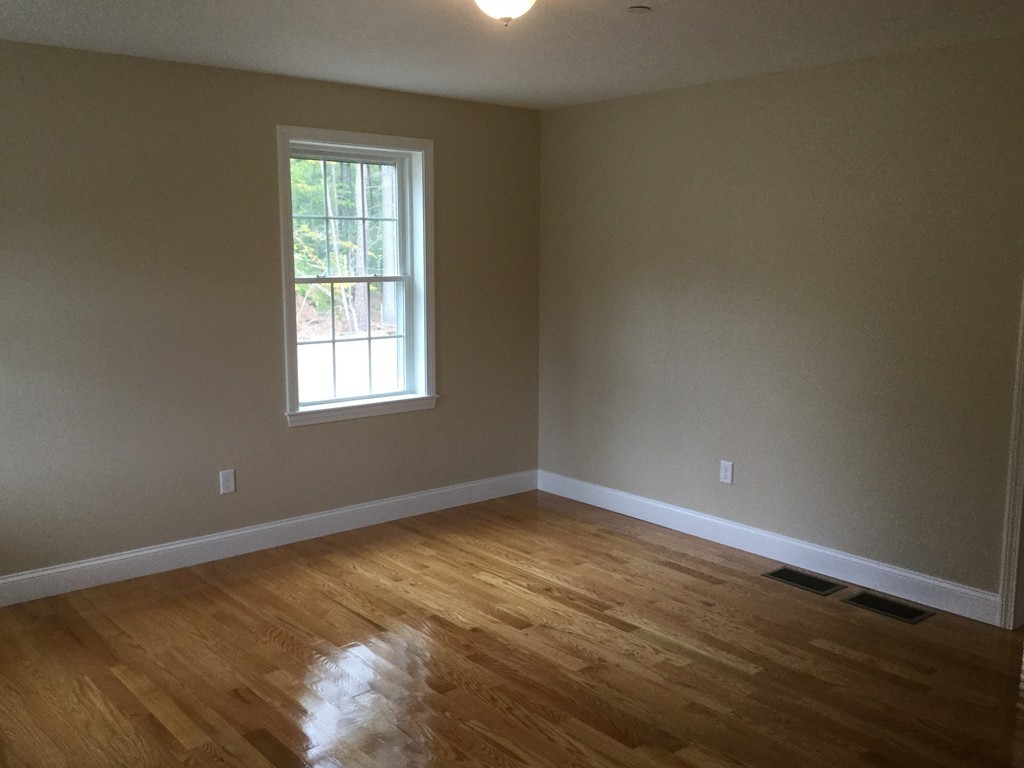 79 Merrimac Road Haverhill, MA 01830 - Photo 12 of 13 an empty room with wooden floor and windows