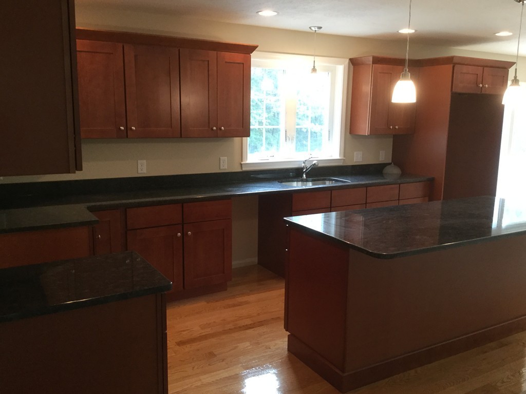 79 Merrimac Road Haverhill, MA 01830 - Photo 4 of 13 a kitchen with kitchen island granite countertop a sink a window stainless steel appliances and cabinets