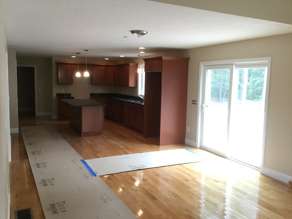 79 Merrimac Road Haverhill, MA 01830 - Photo 6 of 13 a open kitchen with kitchen island a sink granite counter tops and a living room view