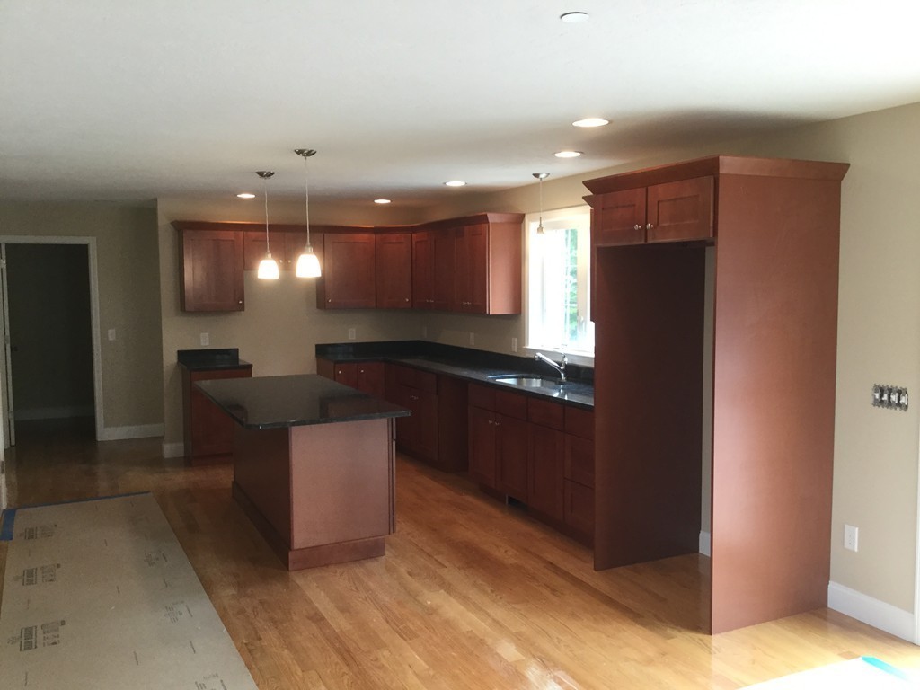 79 Merrimac Road Haverhill, MA 01830 - Photo 7 of 13 a kitchen with a refrigerator and a counter top space