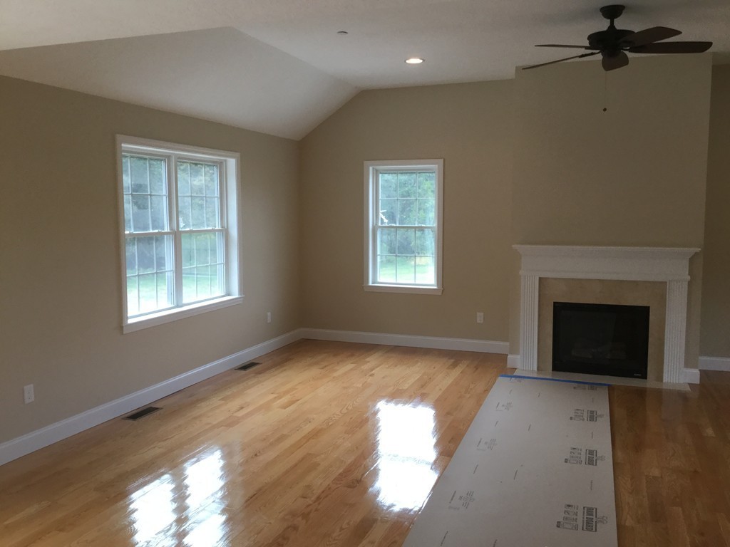 79 Merrimac Road Haverhill, MA 01830 - Photo 8 of 13 a view of an empty room with a window and fireplace