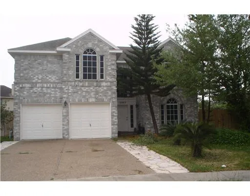a front view of house with a garden