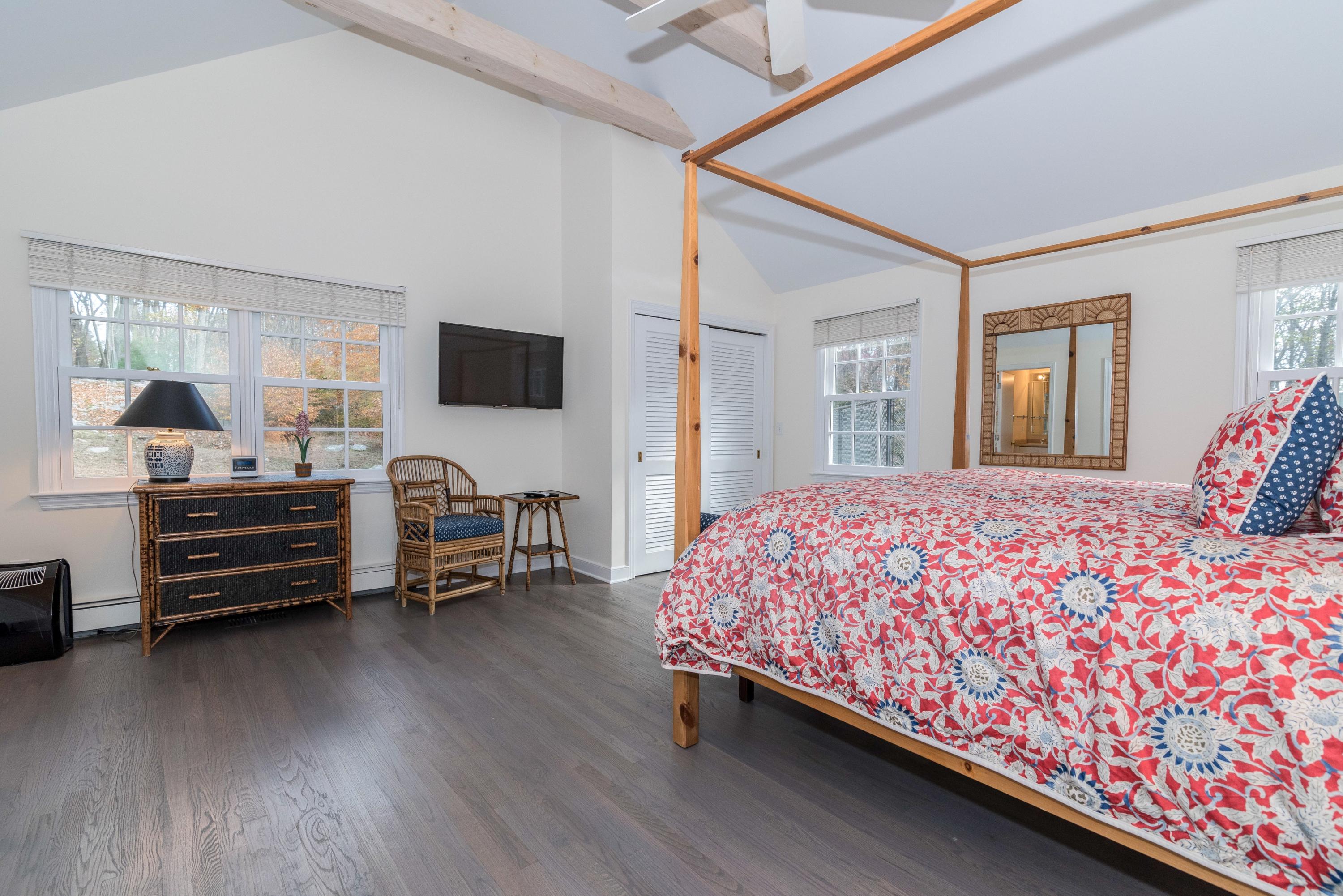 782 Smith Ridge Road New Canaan, CT 06840 - Photo 14 of 25 a bedroom with a bed and a chandelier