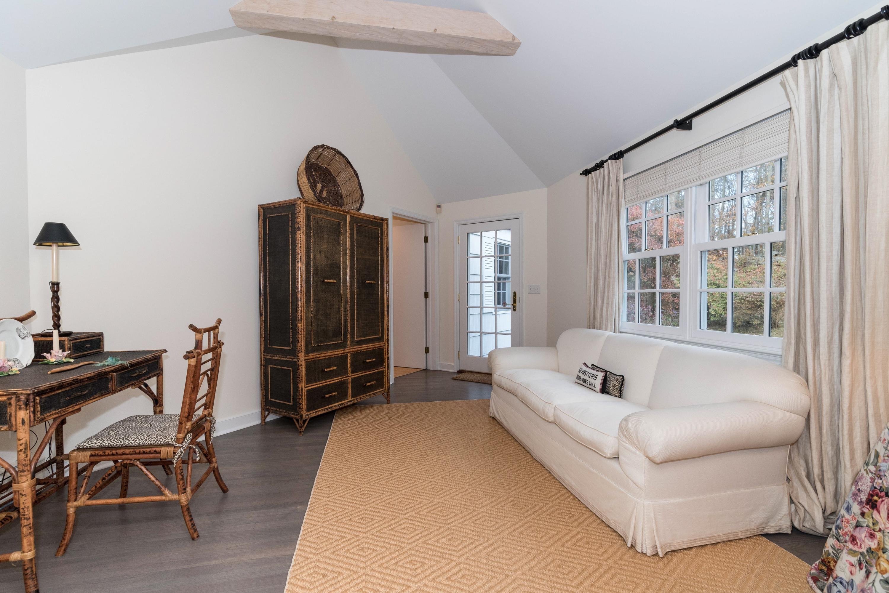 782 Smith Ridge Road New Canaan, CT 06840 - Photo 19 of 25 a living room with furniture a rug potted plant and a window
