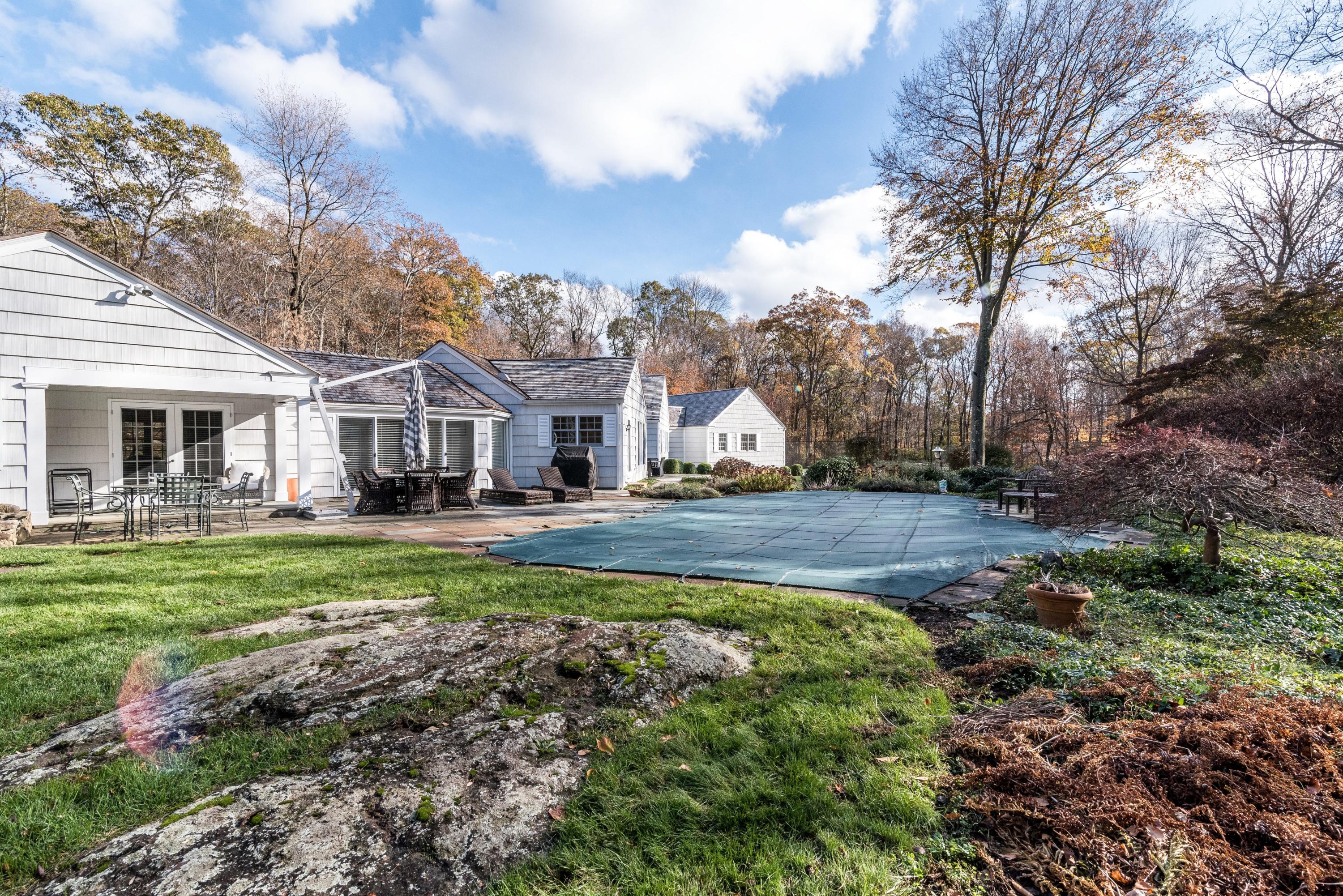 782 Smith Ridge Road New Canaan, CT 06840 - Photo 22 of 25 a front view of a house with a yard