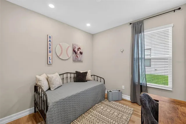 a bedroom with a bed and a lamp on table