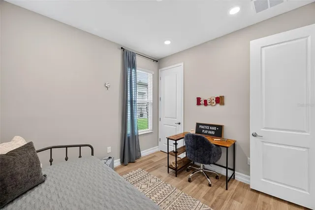 a bathroom with a sink a toilet a mirror and shower