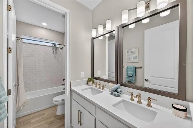 a kitchen that has a lot of cabinets a sink and appliances in it