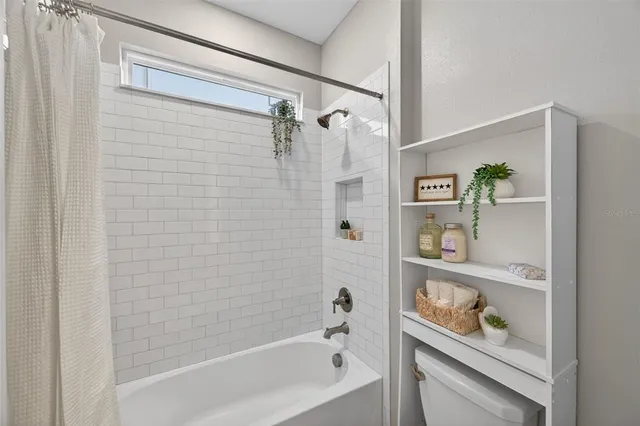 a kitchen with stainless steel appliances a kitchen island a stove a table and chairs in it