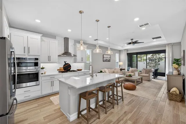 a bedroom with bed and a chandelier