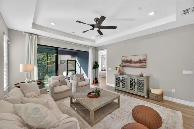 a living room with furniture and a floor to ceiling window