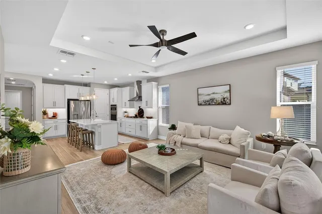 a living room with furniture and a floor to ceiling window