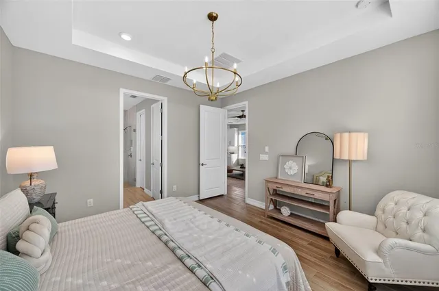 a view of a house with a yard and potted plants
