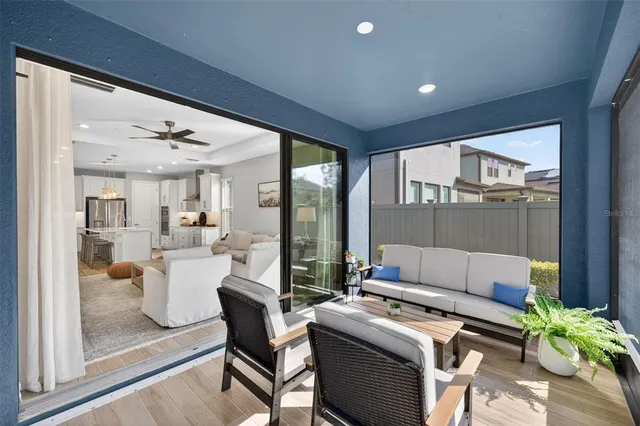 a living room with furniture a fireplace and chandelier