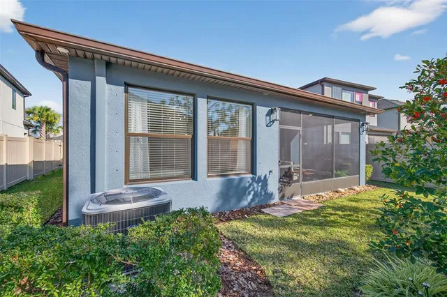 a front view of a house with a garden and lake view